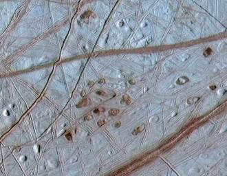 PIA03878: Ruddy "Freckles" on Europa