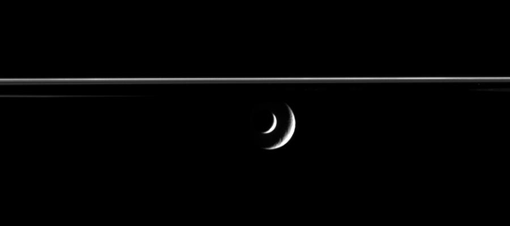 PIA08350: Enceladus Transits Rhea