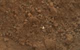 PIA16233: Bright Particle in Hole Dug by Scooping of Martian Soil